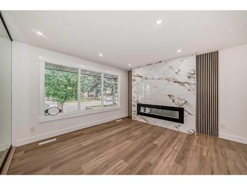 8628 Atlas Drive Se, Calgary, AB - Indoor Photo Showing Living Room With Fireplace