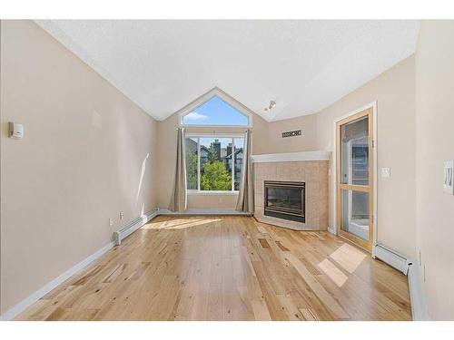 406-10 Sierra Morena Mews, Calgary, AB - Indoor Photo Showing Living Room With Fireplace