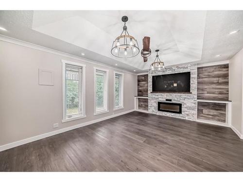 11 Centre Street, Strathmore, AB - Indoor Photo Showing Other Room With Fireplace