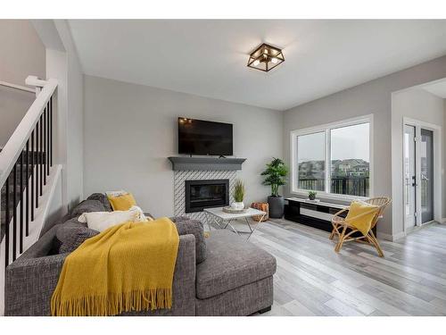 523 Kingsmere Way Se, Airdrie, AB - Indoor Photo Showing Living Room With Fireplace