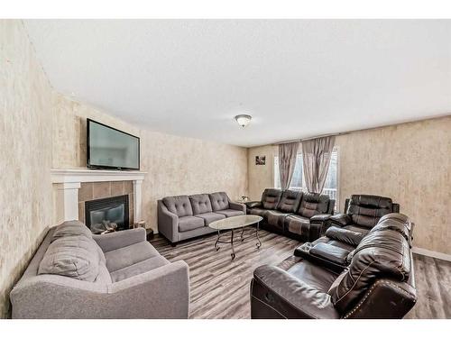 1351 Kings Heights Road Se, Airdrie, AB - Indoor Photo Showing Living Room With Fireplace