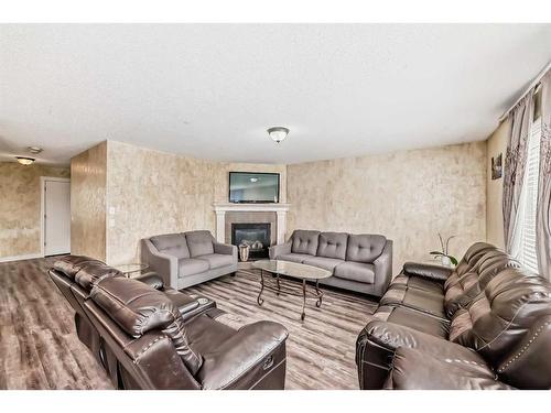 1351 Kings Heights Road Se, Airdrie, AB - Indoor Photo Showing Living Room With Fireplace