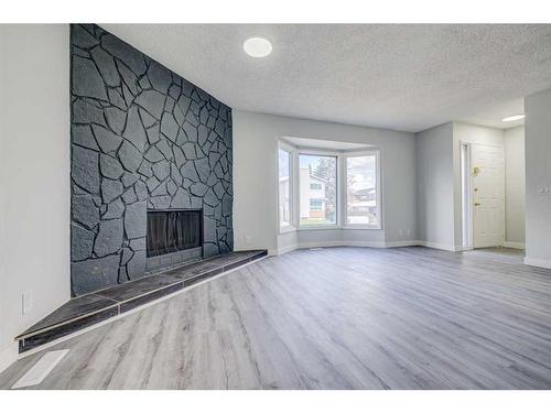 12 Castleglen Crescent Ne, Calgary, AB - Indoor Photo Showing Other Room With Fireplace