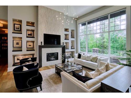 92 Hawk'S Landing Drive, Priddis Greens, AB - Indoor Photo Showing Living Room With Fireplace