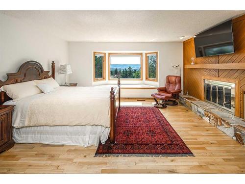 16 Silvercreek Place Nw, Calgary, AB - Indoor Photo Showing Bedroom With Fireplace