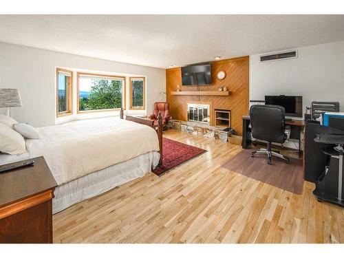 16 Silvercreek Place Nw, Calgary, AB - Indoor Photo Showing Bedroom With Fireplace