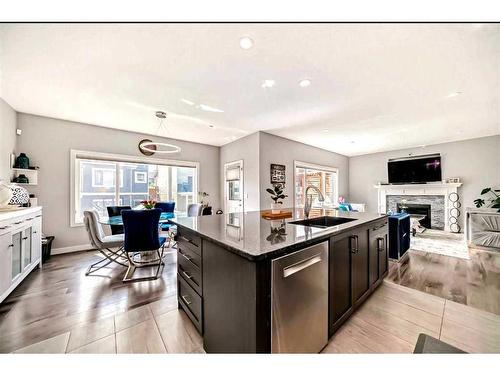 1358 Bayside Drive Sw, Airdrie, AB - Indoor Photo Showing Kitchen With Fireplace With Upgraded Kitchen