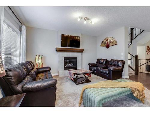 1338 Kings Heights Way Se, Airdrie, AB - Indoor Photo Showing Living Room With Fireplace