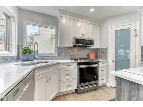 81 Gleneagles Close, Cochrane, AB - Indoor Photo Showing Kitchen With Double Sink With Upgraded Kitchen