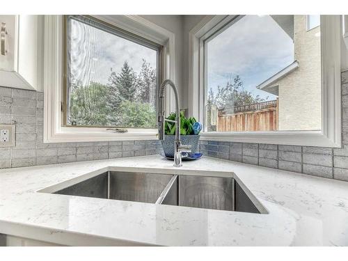 81 Gleneagles Close, Cochrane, AB - Indoor Photo Showing Kitchen With Double Sink