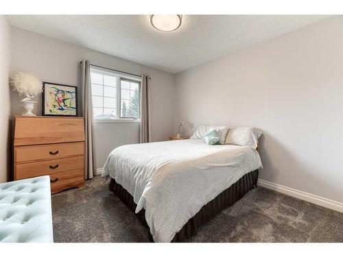 81 Gleneagles Close, Cochrane, AB - Indoor Photo Showing Bedroom