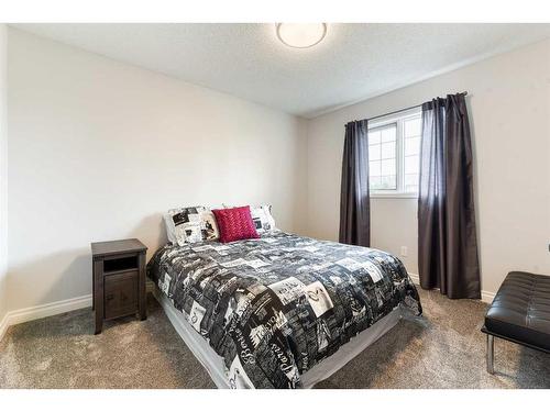 81 Gleneagles Close, Cochrane, AB - Indoor Photo Showing Bedroom