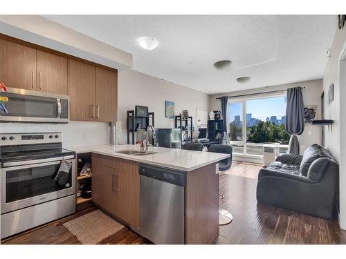 407-605 17 Avenue Nw, Calgary, AB - Indoor Photo Showing Kitchen With Stainless Steel Kitchen With Double Sink