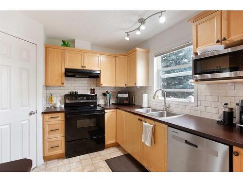 109 Prairie Sound Circle Nw, High River, AB - Indoor Photo Showing Kitchen With Double Sink