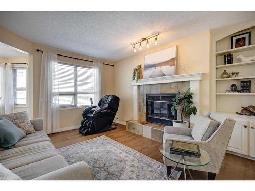 27 Woodford Court Sw, Calgary, AB - Indoor Photo Showing Living Room With Fireplace