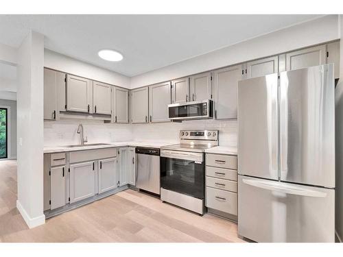 3-310 Brookmere Road Sw, Calgary, AB - Indoor Photo Showing Kitchen With Stainless Steel Kitchen With Upgraded Kitchen