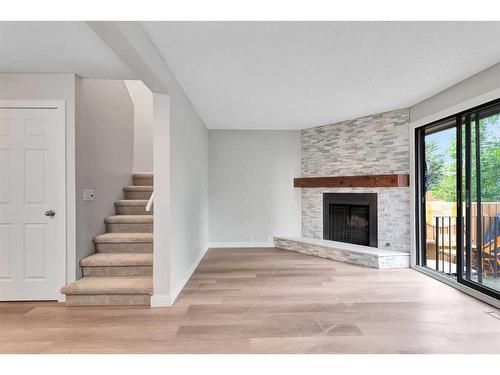 3-310 Brookmere Road Sw, Calgary, AB - Indoor Photo Showing Living Room With Fireplace