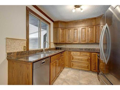 455 Queen Charlotte Drive Se, Calgary, AB - Indoor Photo Showing Kitchen With Double Sink