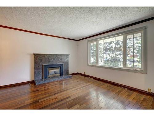 455 Queen Charlotte Drive Se, Calgary, AB - Indoor Photo Showing Living Room With Fireplace