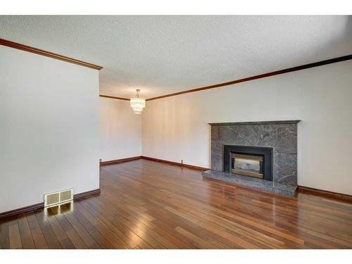 455 Queen Charlotte Drive Se, Calgary, AB - Indoor Photo Showing Living Room With Fireplace