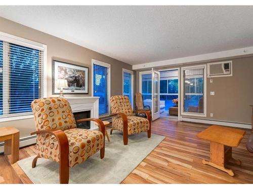 132-7229 Sierra Morena Boulevard Sw, Calgary, AB - Indoor Photo Showing Living Room With Fireplace