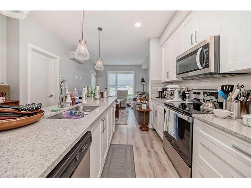 112-150 Shawnee Square Sw, Calgary, AB - Indoor Photo Showing Kitchen With Double Sink With Upgraded Kitchen