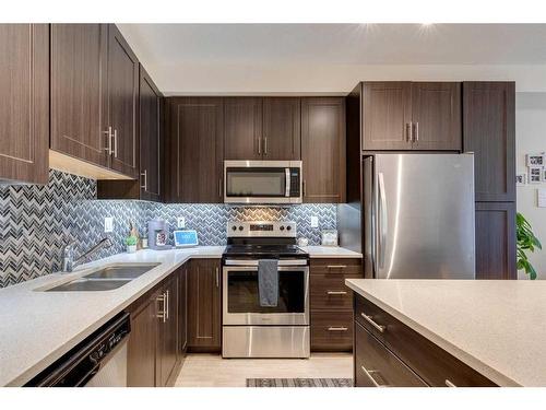 7102-151 Legacy Main Street Se, Calgary, AB - Indoor Photo Showing Kitchen With Stainless Steel Kitchen With Double Sink With Upgraded Kitchen