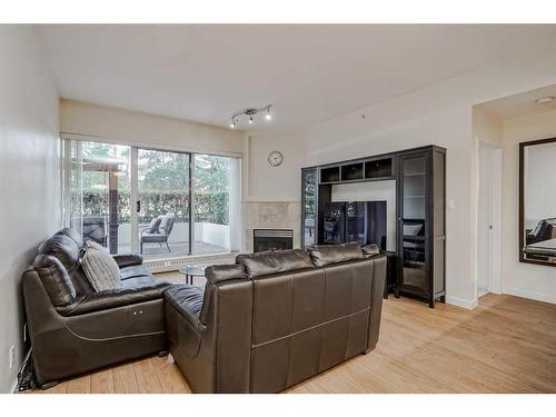 102-1108 6 Avenue Sw, Calgary, AB - Indoor Photo Showing Living Room With Fireplace