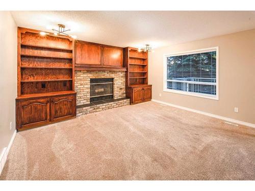 62 Edgebank Circle Nw, Calgary, AB - Indoor Photo Showing Living Room With Fireplace