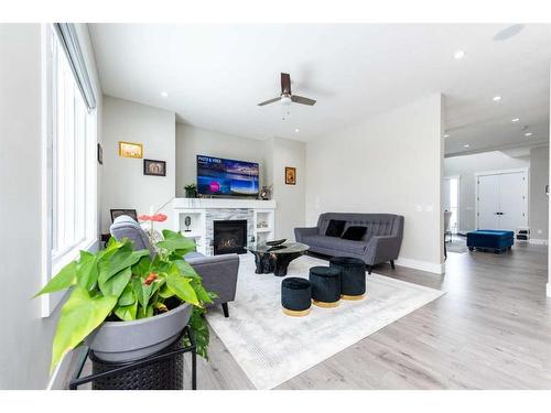 162 Kinniburgh Crescent, Chestermere, AB - Indoor Photo Showing Living Room With Fireplace