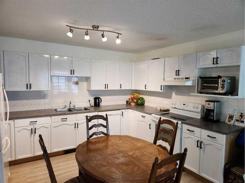 228 Willowbrook Close Nw, Airdrie, AB - Indoor Photo Showing Kitchen With Double Sink