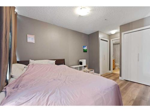 # 202-35 Richard Court Sw, Calgary, AB - Indoor Photo Showing Bedroom