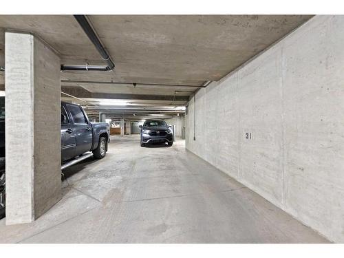 # 202-35 Richard Court Sw, Calgary, AB - Indoor Photo Showing Garage