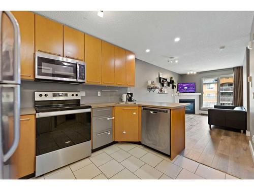 # 202-35 Richard Court Sw, Calgary, AB - Indoor Photo Showing Kitchen With Stainless Steel Kitchen