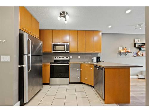 # 202-35 Richard Court Sw, Calgary, AB - Indoor Photo Showing Kitchen With Stainless Steel Kitchen