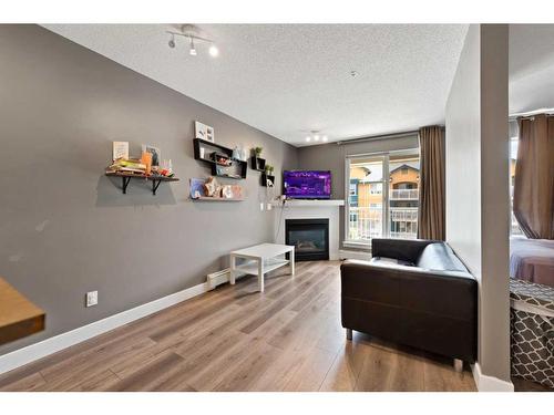 # 202-35 Richard Court Sw, Calgary, AB - Indoor With Fireplace