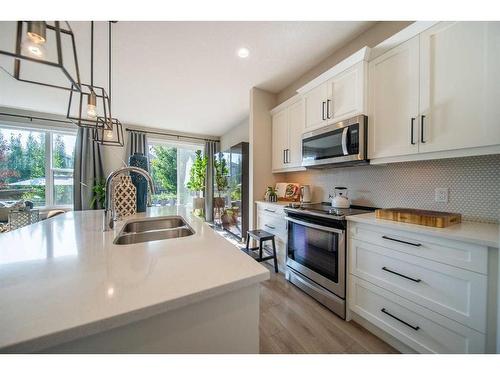 32 Cranbrook Green Se, Calgary, AB - Indoor Photo Showing Kitchen With Double Sink