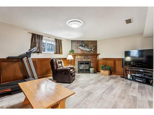 31 Tararidge Court Ne, Calgary, AB - Indoor Photo Showing Living Room With Fireplace