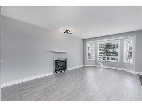 22 Bridleridge Road Sw, Calgary, AB - Indoor Photo Showing Living Room With Fireplace