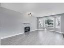 22 Bridleridge Road Sw, Calgary, AB  - Indoor Photo Showing Living Room With Fireplace 