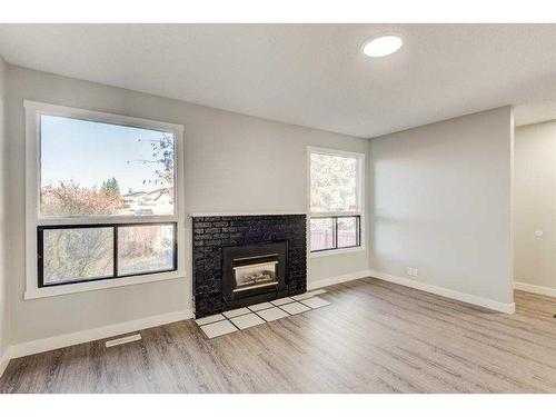 17 Castleglen Road Ne, Calgary, AB - Indoor Photo Showing Living Room With Fireplace