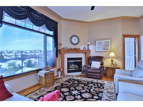 12 Arbour Crest Mount Nw, Calgary, AB - Indoor Photo Showing Living Room With Fireplace