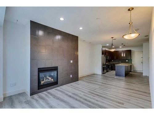 4-2101 17 Street Sw, Calgary, AB - Indoor Photo Showing Living Room With Fireplace