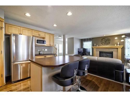 199 Chapman Circle Se, Calgary, AB - Indoor Photo Showing Kitchen With Fireplace