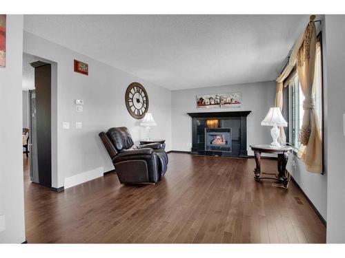 228 Sheep River Lane, Okotoks, AB - Indoor Photo Showing Living Room With Fireplace