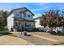 228 Sheep River Lane, Okotoks, AB  - Outdoor With Deck Patio Veranda With Facade 