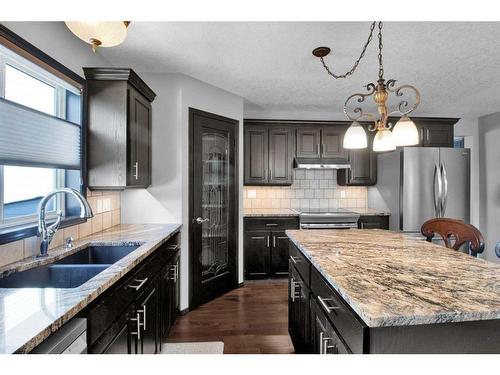 228 Sheep River Lane, Okotoks, AB - Indoor Photo Showing Kitchen With Double Sink With Upgraded Kitchen