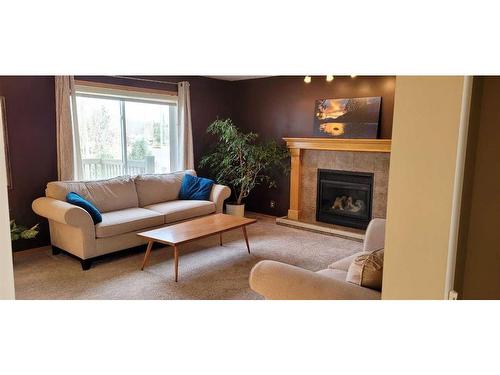 72 Shannon Gardens Sw, Calgary, AB - Indoor Photo Showing Living Room With Fireplace