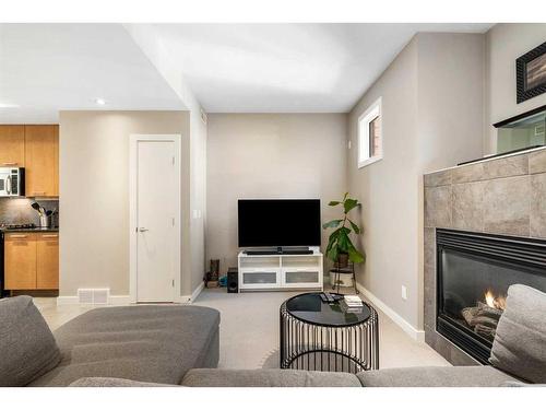 164 9 Street Ne, Calgary, AB - Indoor Photo Showing Living Room With Fireplace