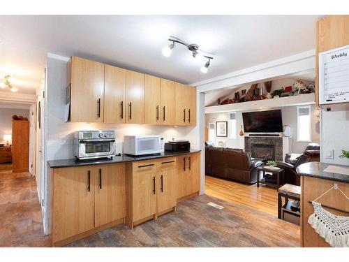 810 Brentwood Crescent, Strathmore, AB - Indoor Photo Showing Kitchen With Fireplace